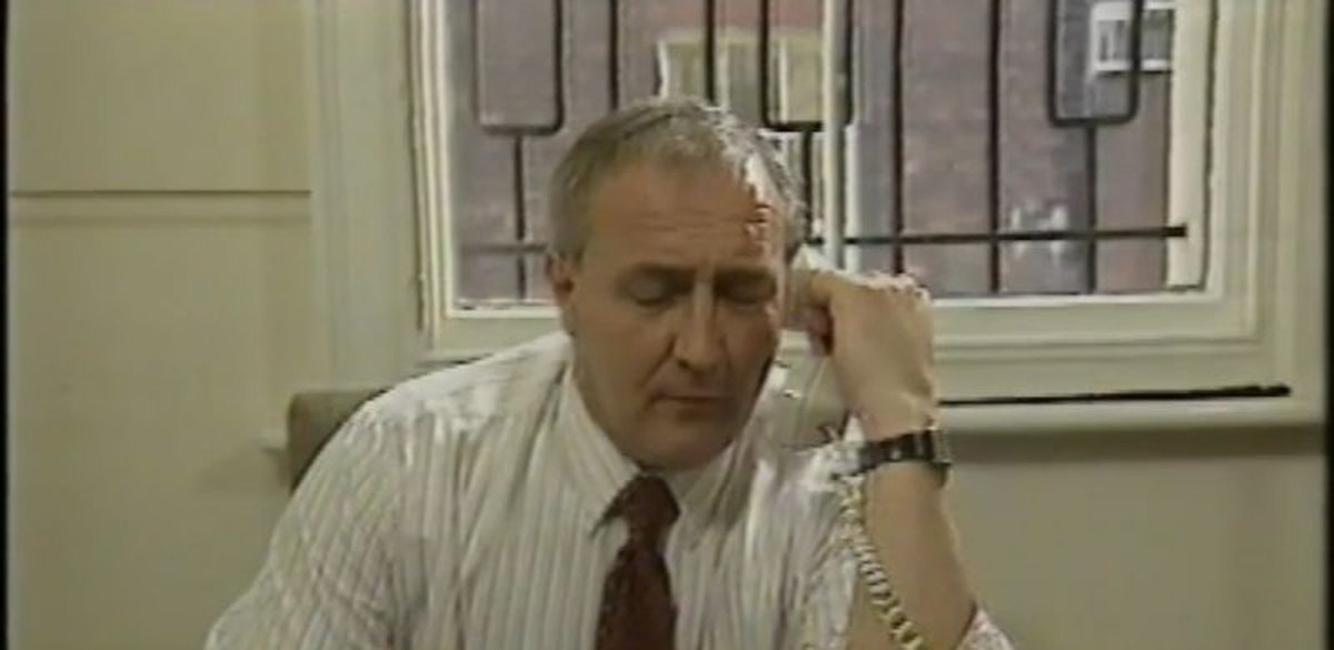 A still from an ITV programme about the recession showing Neil Martin's dad in a shirt and tie, sitting at a desk with a phone to his ear